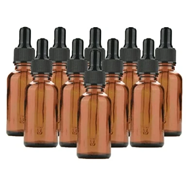 Afbeelding van 10 amberkleurige glazen druppelflessen met zwarte doppen, 30 ml, navulbare voor etherische oliën