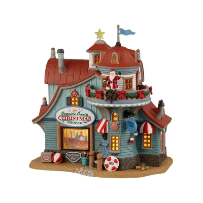 Afbeelding van je Seaside Santa Xmas Shoppe B/O Led Kerst koopt goedkoop bij Warentuin. LEMAX