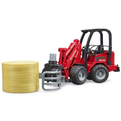 Afbeelding van Schäffer 2630 met balengrijper en ronde baal Bruder, 1:16