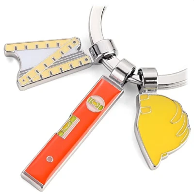 Afbeelding van TROIKA SLEUTELHANGER BOB met 3 bedels, duimstok, waterpas en bouwhelm.